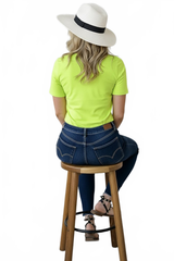 Harlequin Yellow-Green Crewneck Short Sleeve Top Seated Back View with Hat - Wrinkle-Free Travel Clothing | JudyP Apparel